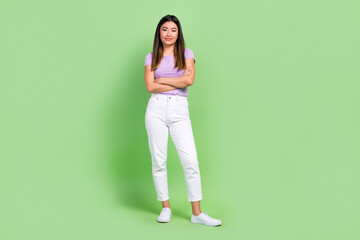 Full body cadre of young confident korean lady crossed arms specialist work in office open studio isolated over green color background