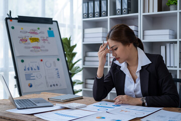 Stressed overworked desperate broke owner manager unhappy business woman, young Asian woman holding sore head pain from law firm taxes race 