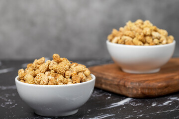 Dried mulberry. Sun-dried mulberry in ceramic bowl. superfood. Vegetarian food concept. healthy snacks. Close up