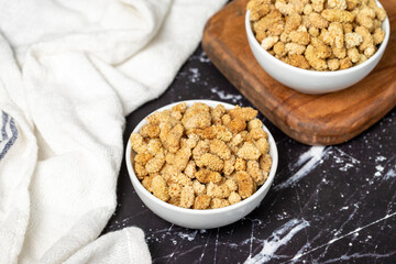 Dried mulberry. Sun-dried mulberry in ceramic bowl. superfood. Vegetarian food concept. healthy snacks