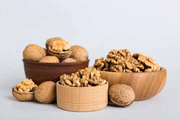 Fresh healthy walnuts in bowl on colored table background. Top view Healthy eating bertholletia concept. Super foods