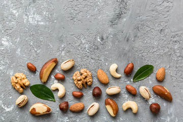 Fototapeta na wymiar Composition of nuts , flat lay - mix hazelnuts, cashews, almonds on table background. healthy eating concepts and food background