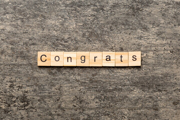 Congrats word written on wood block. Congrats text on cement table for your desing, Top view concept