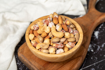 Mixed nuts. Special mixed nuts in a wooden bowl. Nuts, pistachios, peanuts, cashews, almonds. superfood Vegetarian food concept. healthy snacks. Close up
