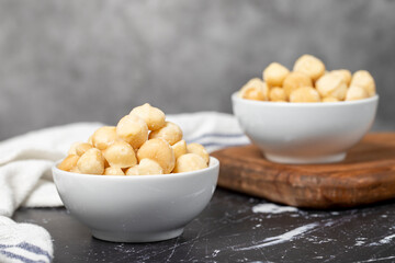 Macadamia nuts. Peeled Macadamia Nuts in a ceramic bowl. superfood. Vegetarian food concept. healthy snacks. Close up