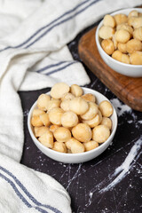 Macadamia nuts. Peeled Macadamia Nuts in a ceramic bowl. superfood. Vegetarian food concept. healthy snacks