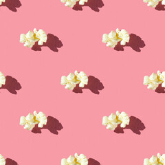seamless pattern of single popcorn on a pink background with hard light