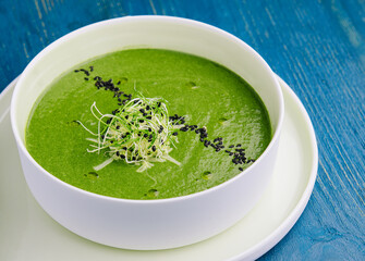 Plate of broccoli and green peas cream soup