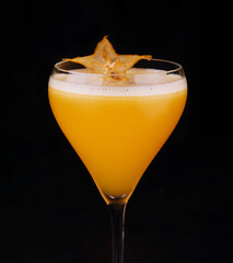 refreshing carambola martini cocktail with champagne