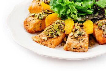 salmon with pistachios, orange slices and lettuce