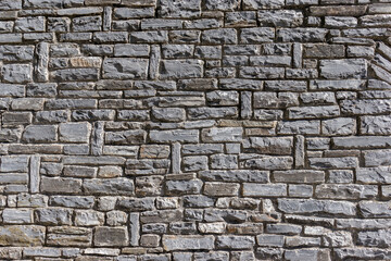 Old rough gray brick stone wall