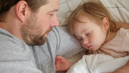 Father and his little daughter toddler girl sleeping together. Healthy sleep. Happy Loving family parent and child sleeping white bed at home. Authentic lifestyle fatherhood moments. Single dad life.