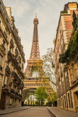 View of the Eiffel Tower from a nearby street full of residential buildings. Paris, France