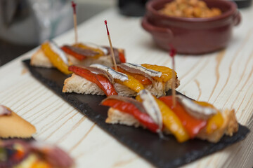 Close up on spanish tapas starters served on a table top. No people are visible. - 603632699