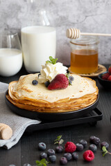 
Fresh pancakes with berries. Breakfast. On a dark background
