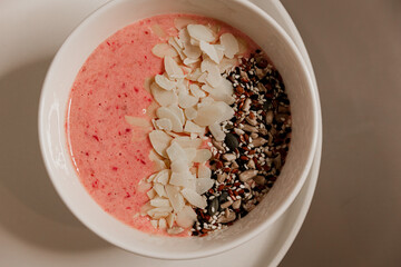 Fruit smoothie bowl garnished with sunflower, sesame, flax seeds and almond petals. Healthy food, health care, healthy breakfasts. Caring for the figure