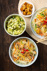 Vegan Rice Noodles with Tofu, Peppers, Carrots on Dark Brown Background