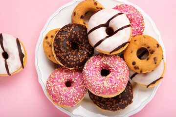 Donuts Doughnuts with Chocolate and Sprinkles on Pink Background