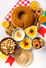 Festa Junina Summer Festival Carnival concept. Brazilian straw hat, popcorn, peanuts and Corn Cake on White Wooden Background