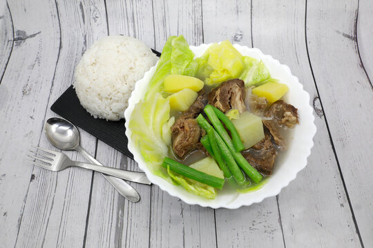 Beef Nilaga or Nilagang Baka is literally translated as &ldquo;Boiled Beef&rdquo;. This is a simple soup dish best served during rainy and cold weather. on wooden background