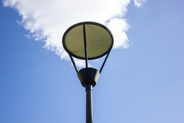Street lamp against the sky. Lantern for lighting the park, during the day.