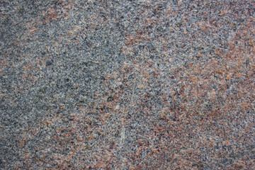 Dark authentic granite.Granite stone,texture,design.Granite facade,rough surface,detail background.
