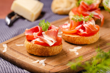 Savory Delights: Mini Rolls with Parma Ham, Parmesan Cheese, and Dill Deli-Style, an Artisanal Combination of Italian Flavors for Elegant Bite-Sized Appetizers