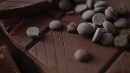 Closeup shot of dark chocolate bar with chocolate chips.