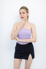 Naklejka premium Portrait isolated cutout closeup shot of millennial Asian young beautiful sexy long hair model in seamless tube cropped top standing posing crossed arms look at camera on white background copy space