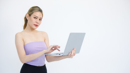 Fototapeta premium Isolated cutout studio shot of Asian excited surprised happy cheerful female model standing smiling looking at laptop computer winning lottery achievement victory goal deal done on white background