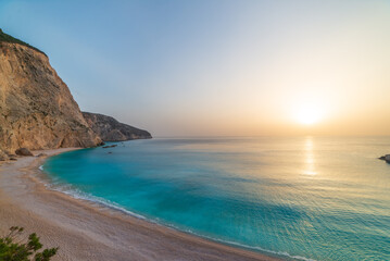 Beautiful beach and water bay in the greek spectacular coast line. Sunset gorgeous sky over blue water unique rocky cliffs. Greece summer top travel destination Lefkada island