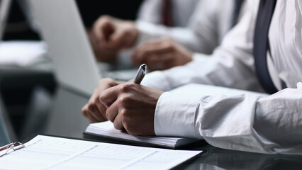 Close-up Of Businessman Filling Customer Survey Form