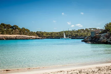 Foto op Canvas Cala S'Amarador beach with white sand and turquoise sea in natural parkland Cala Mondrago bay at Mallorca, Balearic islands, Spain. Sailboats floating on water © encierro