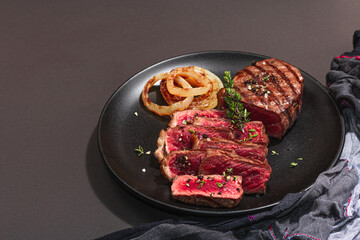 Rare cooking level Sirloin steak with spices and herbs. Classic grilled meat cut ready to eat