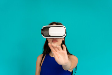 Woman in studio wearing virtual reality glasses in interactive game.