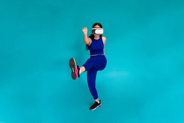 Fototapeta na wymiar Woman jumping while wearing vr glasses.