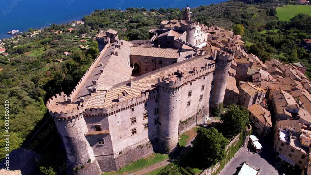 Wall mural Scenic lake and beautiful medieval castle  Bracciano. Italy. lazio region. Aerial drone view of old town and fortress with lake at background