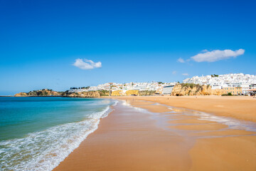 Great view of Fisherman Beach, Praia dos Pescadores, with whitewashed houses on cliff, Albufeira,...