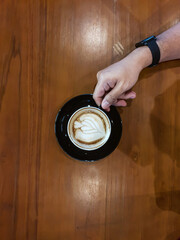 hand holding a cup of latte 
