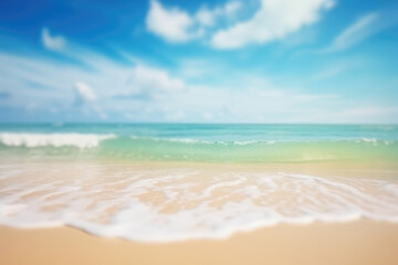 Fototapeta na wymiar Abstract blur defocused background. Tropical summer beach with golden sand, turquoise ocean and blue sky with white clouds on bright sunny day. Colorful landscape for summer holidays.