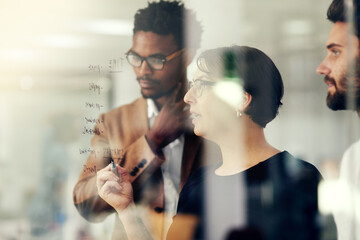 Glass, leader and woman brainstorming with team or planning strategy for a startup company or small business. Teamwork, our vision and group of employees in a meeting for a idea of innovation