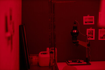 Darkroom with red lighting and special equipment for making photo