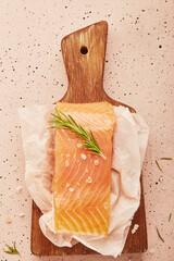 Fresh fillet of smoked salmon on wooden cutting board close up