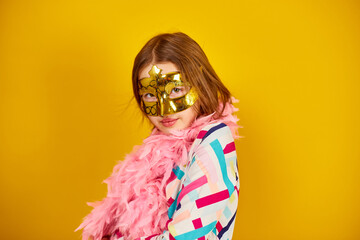 A joyful teenager girl wearing a colorful Brazil carnival mask