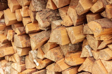 Split birch logs for the fireplace are stacked on top of each other. Wood for a picnic. Betulaceae. Firewood