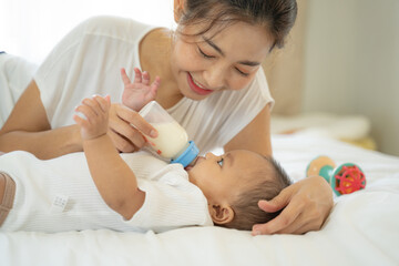 Mom and Newborn,Happy family concept.Close up view of beautiful Asian mother and her sleeping...
