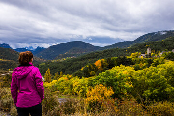 Fototapeta na wymiar Young woman in autumn in Ordesa and Monte Perdido National Park, Spain