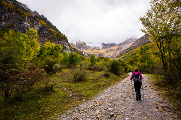 Fototapeta premium Young woman in autumn in Ordesa and Monte Perdido National Park, Spain