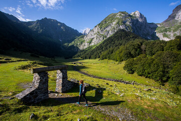 Summer and young girl in Uelhs Deth Joeu waterfall, Val D Aran, Spain