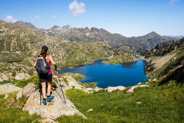Young hiker girl summit to Ratera Peak in Aiguestortes and Sant Maurici National Park, Spain